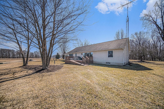 exterior space with a wooden deck, a yard, and roof with shingles