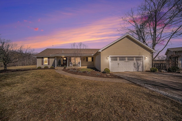 ranch-style home with aphalt driveway, a garage, a porch, and a yard