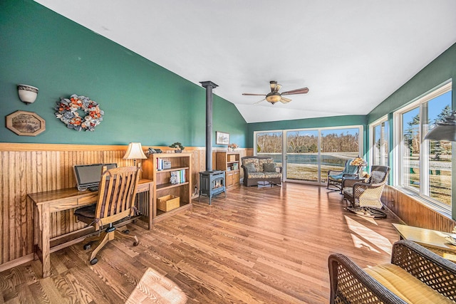 home office with a healthy amount of sunlight, lofted ceiling, and wood finished floors