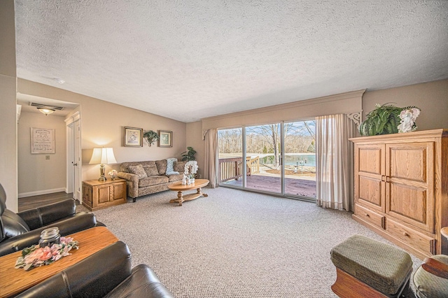 living room featuring lofted ceiling, carpet, and a textured ceiling