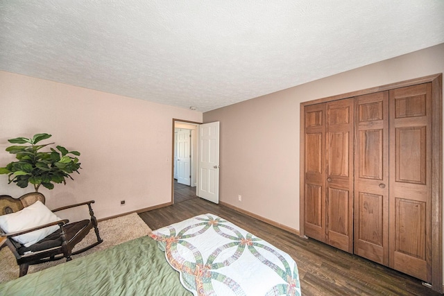 unfurnished bedroom with a textured ceiling, dark wood-type flooring, and baseboards