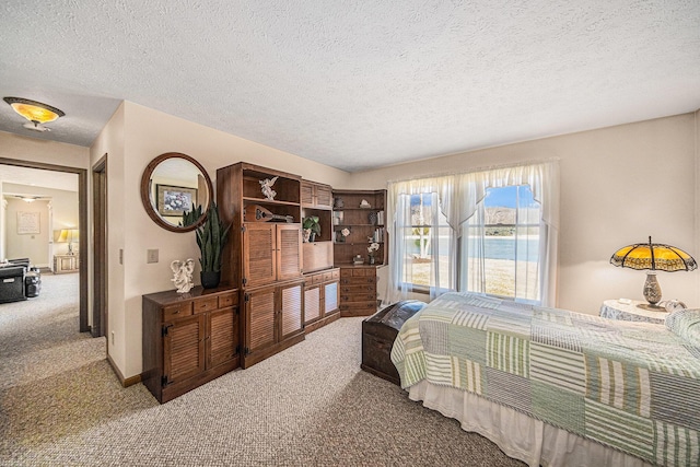 carpeted bedroom featuring baseboards and a textured ceiling