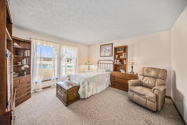 carpeted bedroom with baseboards and a textured ceiling