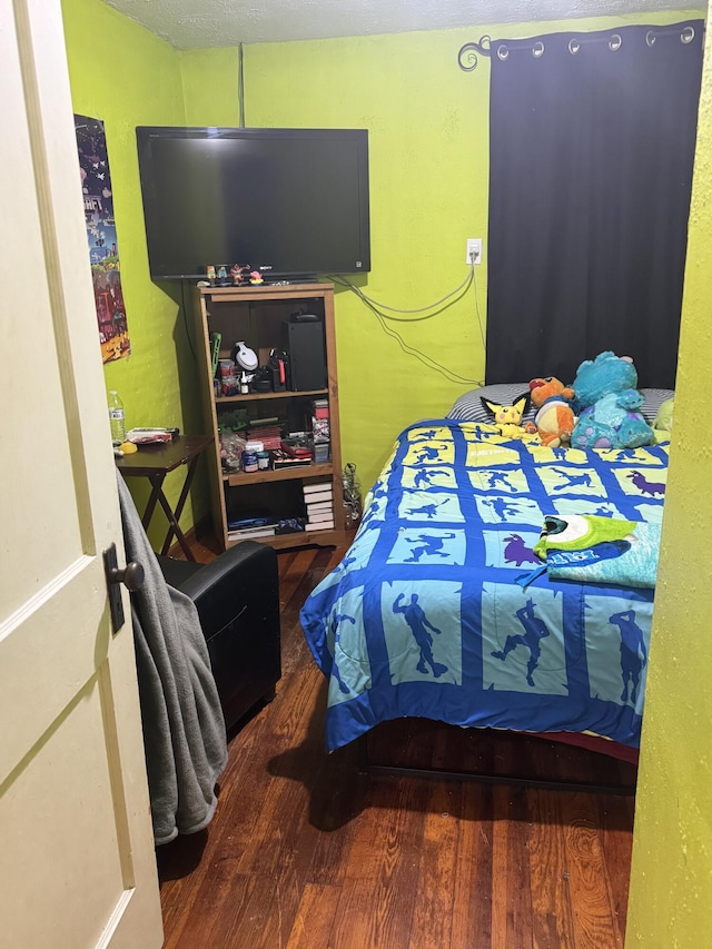 bedroom with wood-type flooring