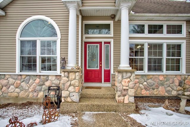 view of snow covered property entrance