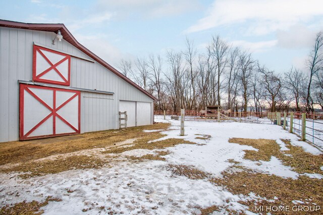 snowy yard featuring an outdoor structure