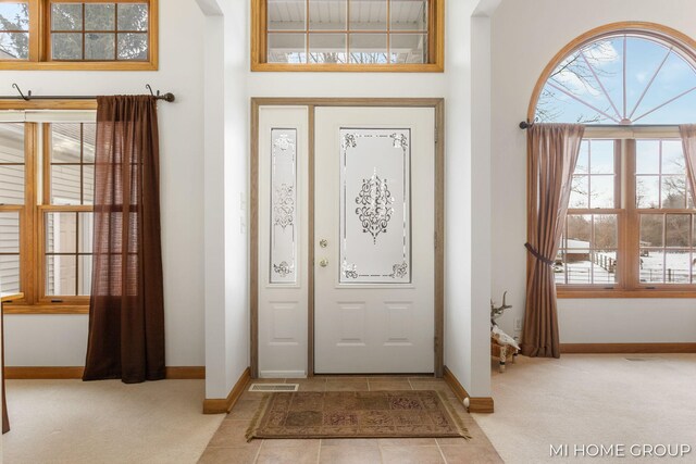 entryway featuring light carpet