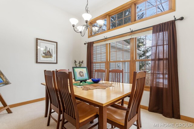 carpeted dining space with a chandelier