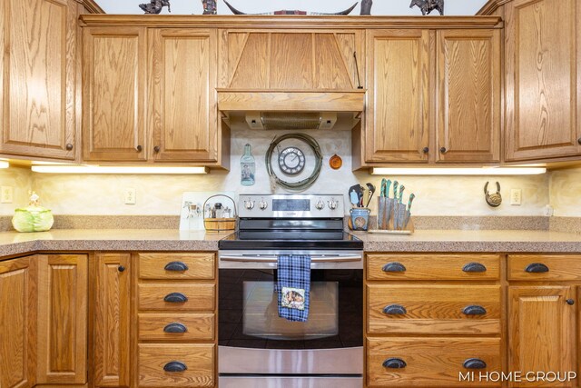 kitchen featuring custom exhaust hood and stainless steel electric range oven