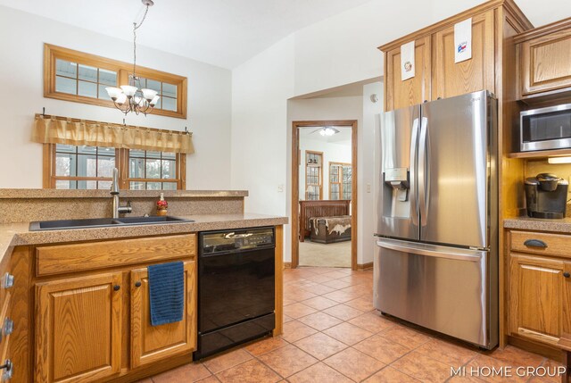 kitchen featuring pendant lighting, sink, an inviting chandelier, stainless steel appliances, and light tile patterned flooring