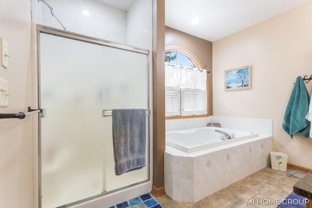 bathroom featuring tile patterned flooring and shower with separate bathtub