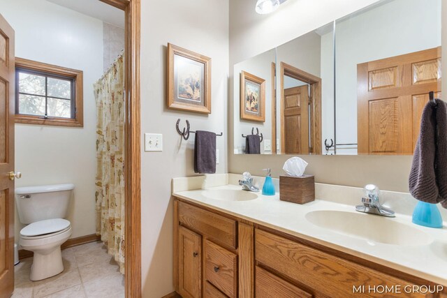 bathroom featuring tile patterned flooring, vanity, a shower with shower curtain, and toilet