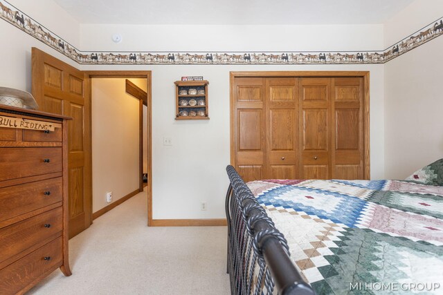 bedroom featuring light carpet and a closet