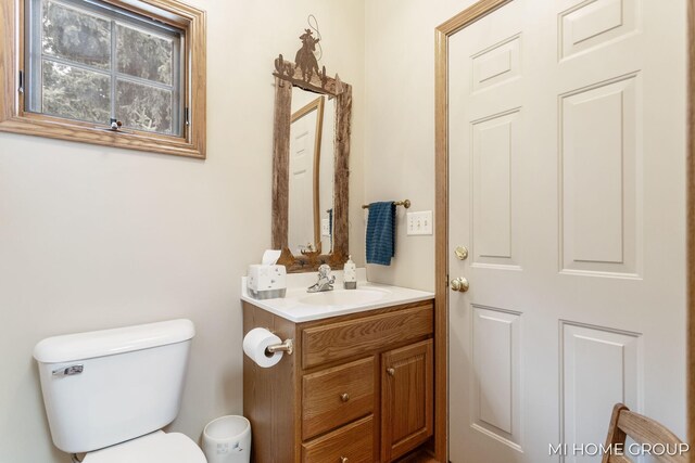 bathroom featuring vanity and toilet