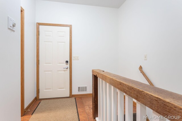 corridor featuring light tile patterned floors