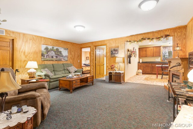 living room with carpet floors and wooden walls