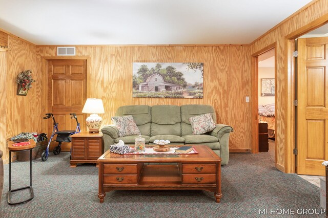 carpeted living room with wood walls