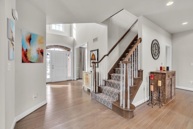 entryway featuring baseboards, visible vents, and wood finished floors