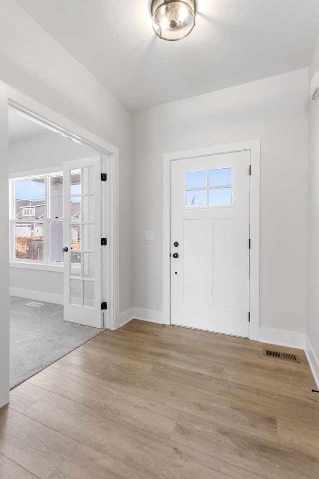 foyer with light hardwood / wood-style flooring