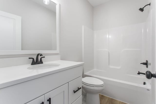 full bathroom with hardwood / wood-style flooring, shower / bathtub combination, vanity, and toilet