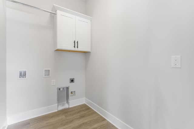 clothes washing area featuring cabinets, washer hookup, light hardwood / wood-style floors, and electric dryer hookup