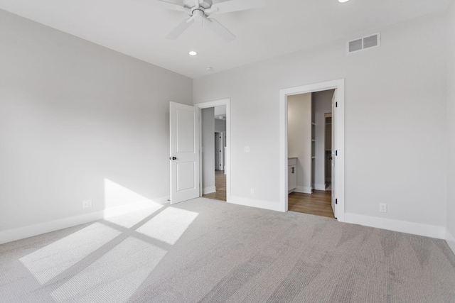 unfurnished bedroom featuring ceiling fan, connected bathroom, and carpet floors