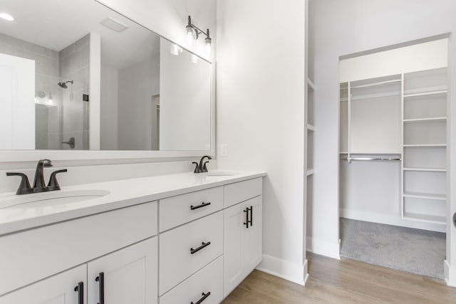 bathroom featuring vanity, hardwood / wood-style flooring, and walk in shower