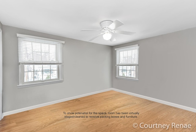 empty room featuring baseboards, a ceiling fan, and wood finished floors