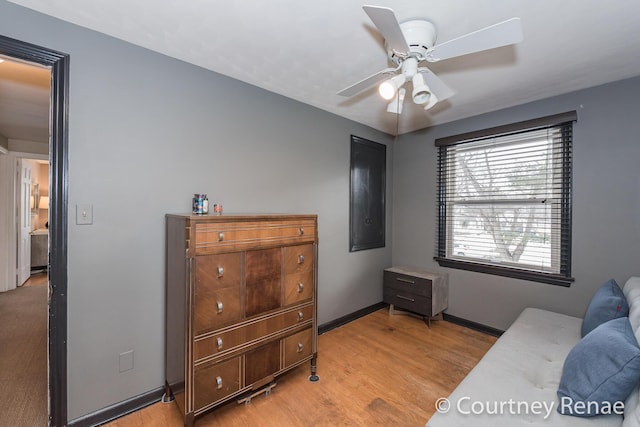 interior space with ceiling fan, baseboards, and light wood-style floors