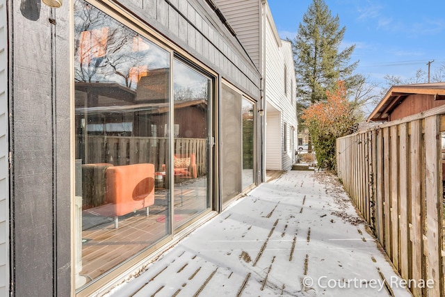 wooden terrace featuring fence