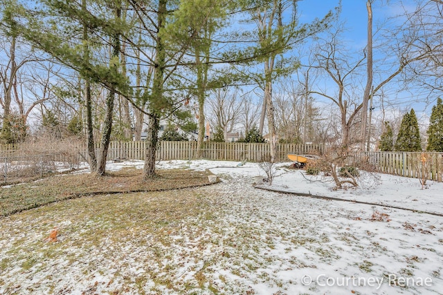 snowy yard with fence