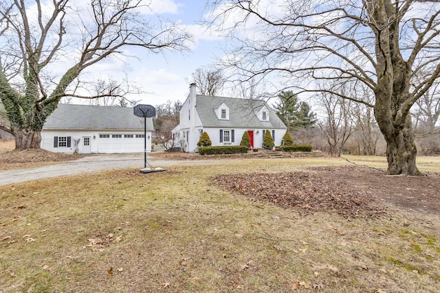 cape cod house featuring a garage and a front yard