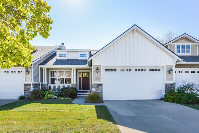 craftsman inspired home with a front yard and covered porch