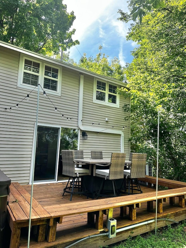 back of house featuring a wooden deck