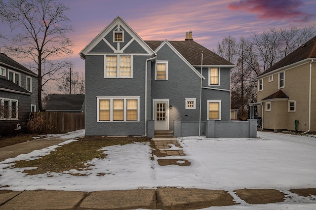 view of back house at dusk