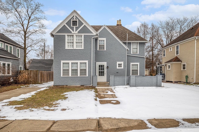 view of snow covered rear of property