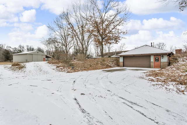 yard covered in snow with a garage