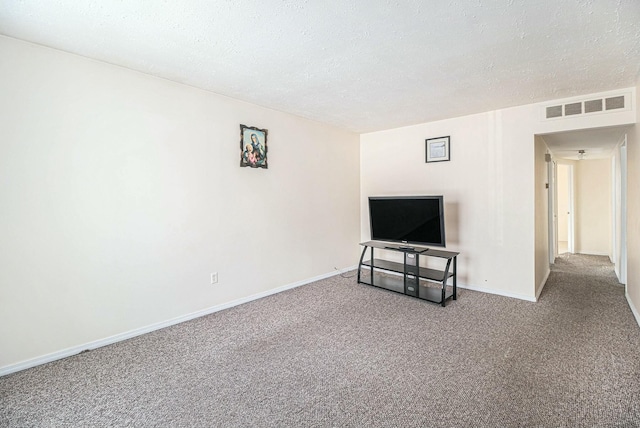 unfurnished living room featuring carpet floors and a textured ceiling