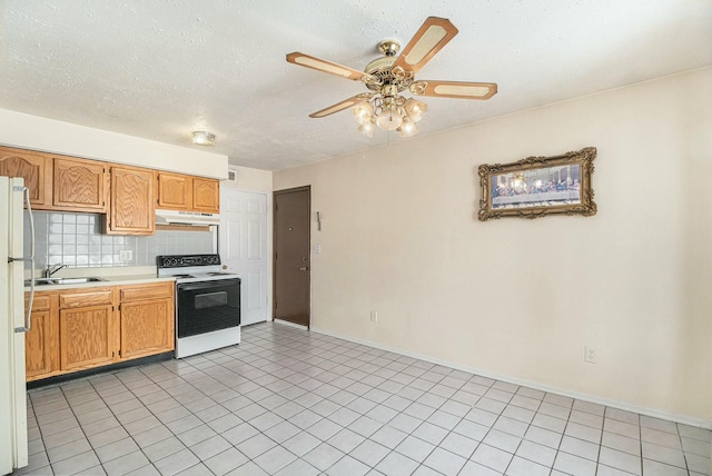 kitchen featuring sink, a textured ceiling, light tile patterned floors, white appliances, and backsplash