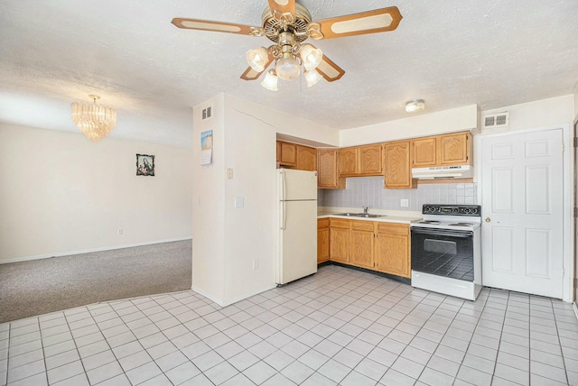 kitchen with sink, white appliances, tasteful backsplash, a textured ceiling, and light carpet