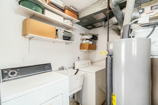 clothes washing area featuring water heater, washer / dryer, and sink