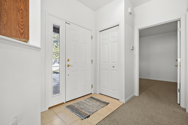 entryway with light colored carpet