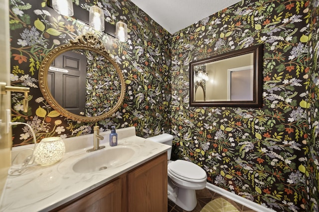 half bathroom featuring vanity, tile patterned floors, toilet, and wallpapered walls