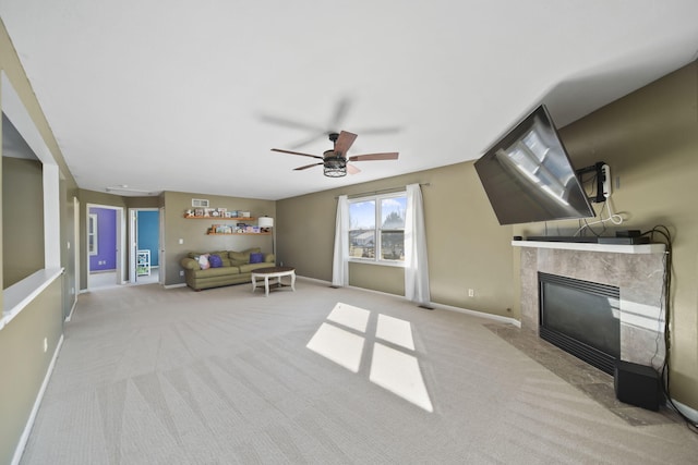 interior space with light carpet, a ceiling fan, a high end fireplace, and baseboards