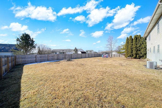 view of yard featuring a fenced backyard and central air condition unit