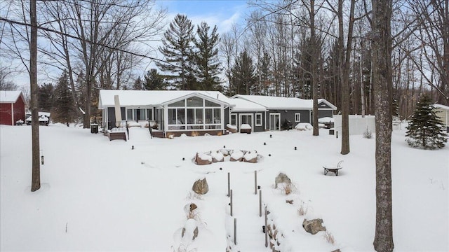 view of front of property with a garage and a sunroom