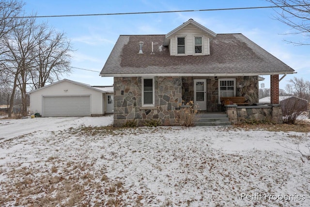 view of front of home with an outbuilding, a porch, and a garage