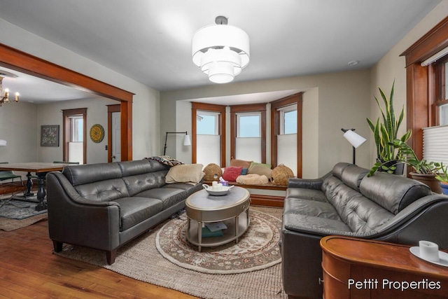 living room featuring hardwood / wood-style flooring and an inviting chandelier