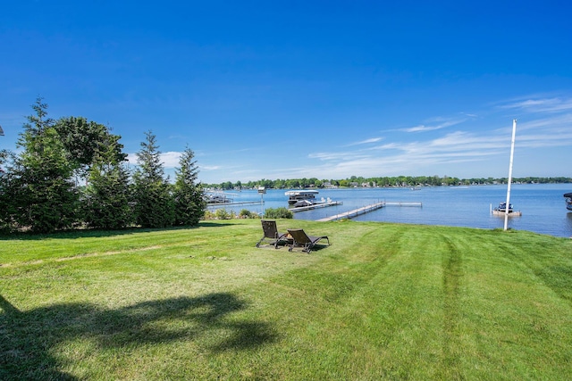 view of yard featuring a dock and a water view