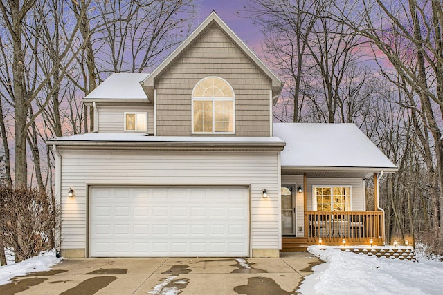 view of front property featuring a porch and a garage